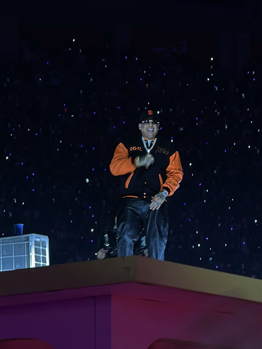 Ñengo Flow performing during the Bad Bunny concert in Lima wearing the Xtextile varsity jacket