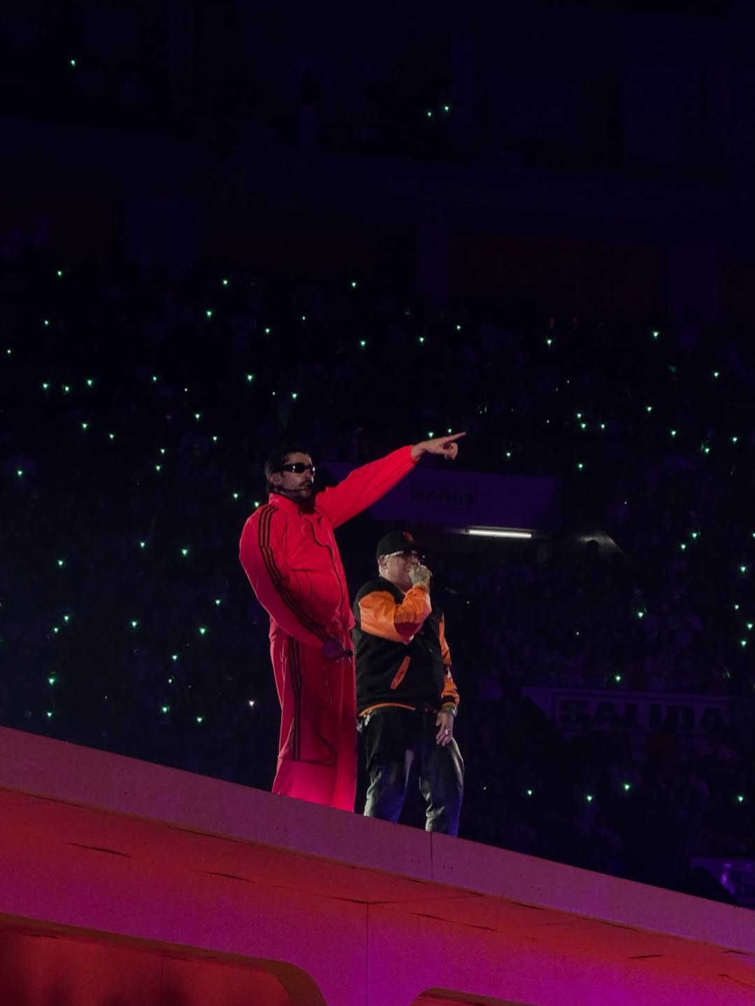 Ñengo Flow on stage in Lima wearing the selected one-of-one Xtextile varsity jacket