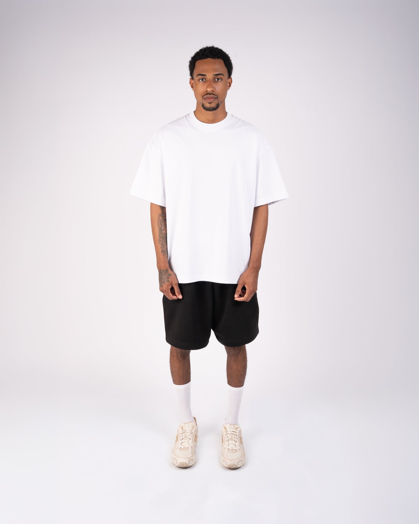 Front view of an oversized white XBLANKS premium T-shirt