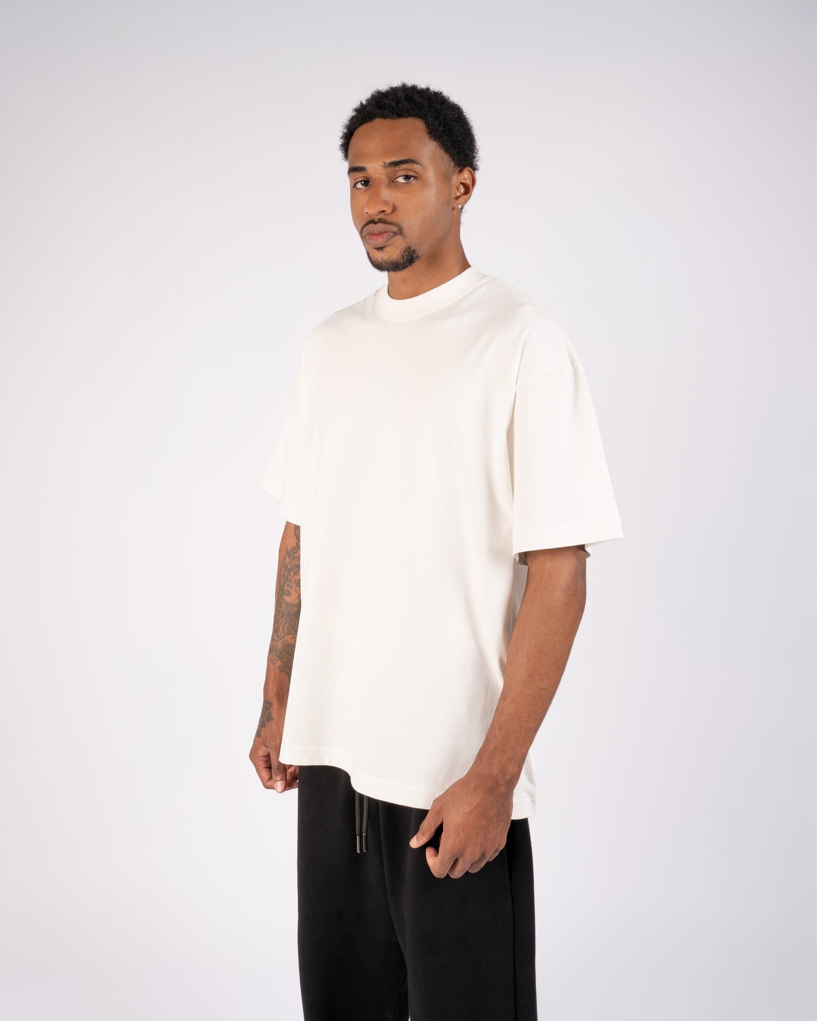 Model wearing an oversized white XBLANKS premium T-shirt