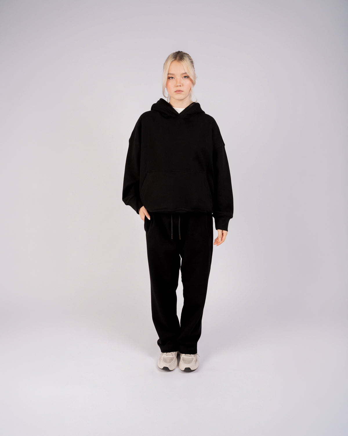 Model wearing a black oversized XBLANKS premium hoodie