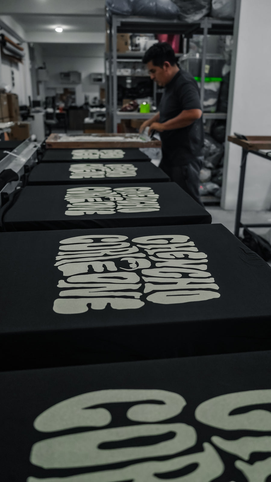 Multiple Chencho Corleone back graphics being screen printed