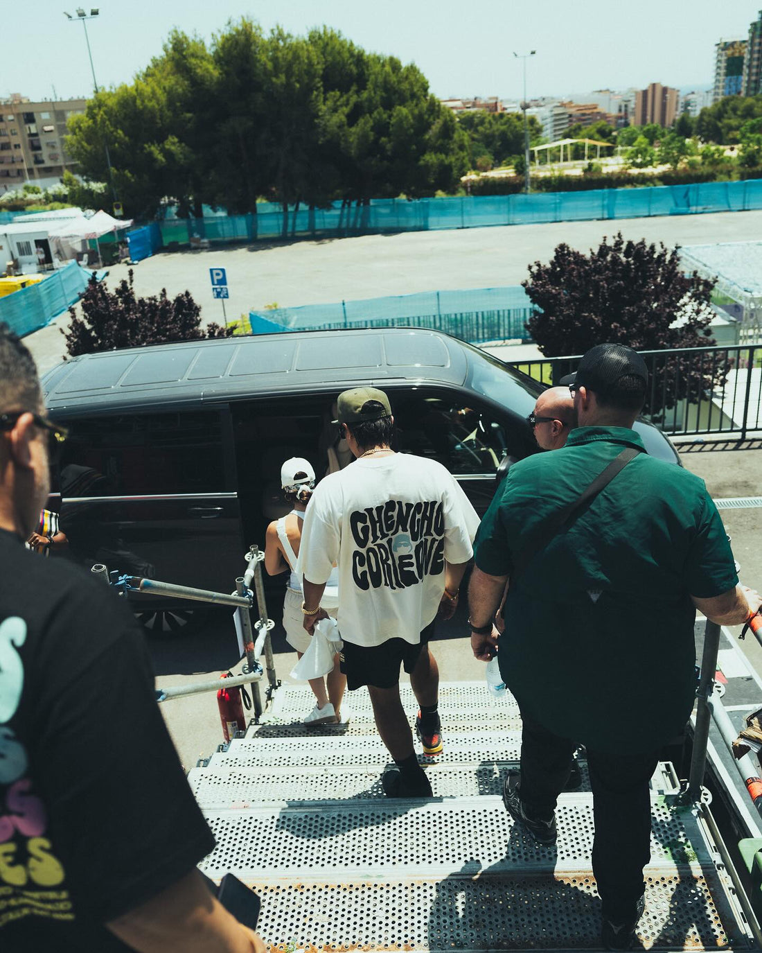 Chencho Corleone team wearing custom off-white T-shirts during event movement