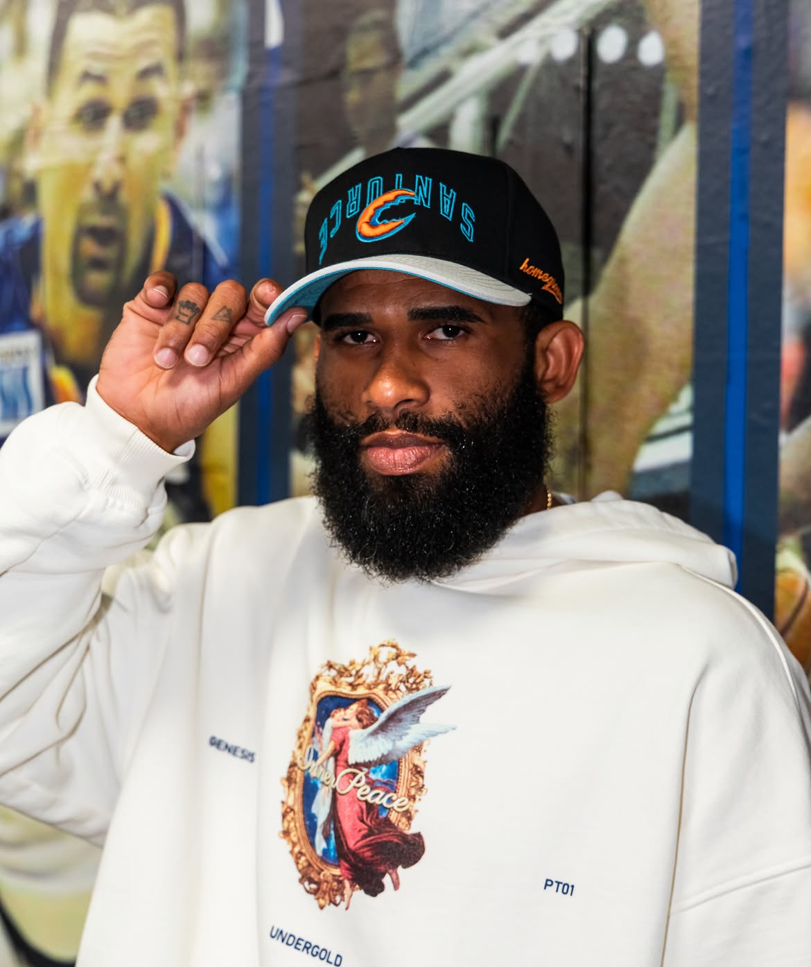 Finished black BSN cap worn in front of a basketball mural in Puerto Rico