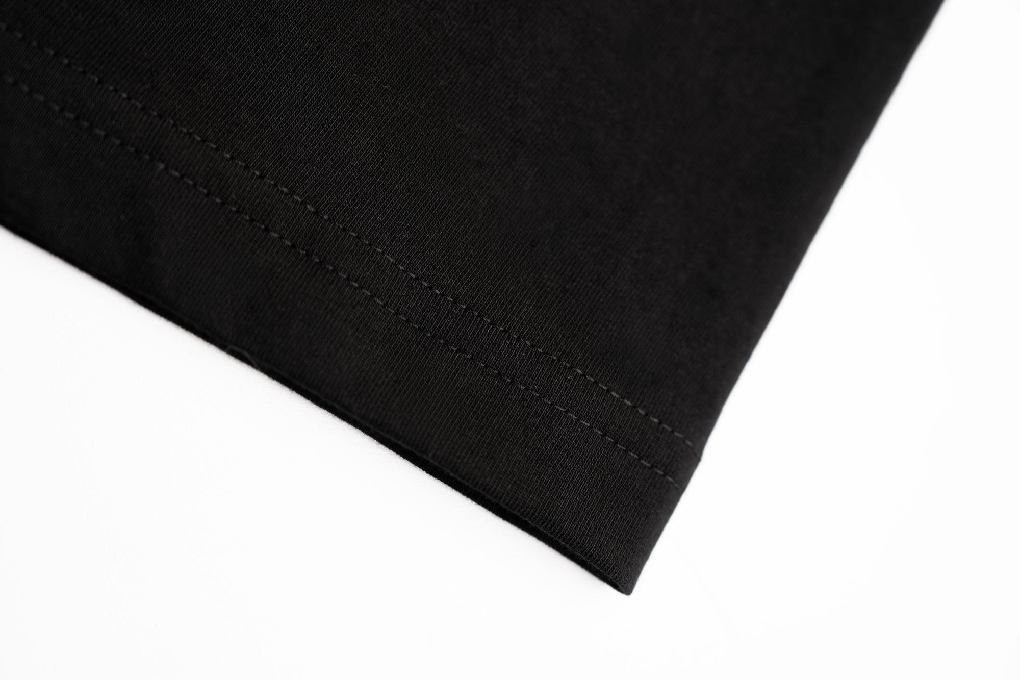 Close-up of premium T-shirt construction and hem finishing