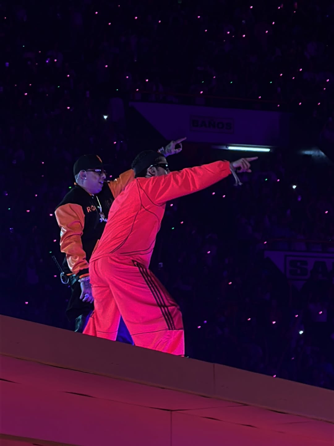 Ñengo Flow wearing the Xtextile varsity jacket during the Bad Bunny concert in Lima